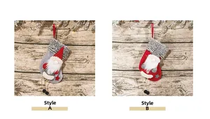 Detailed comparison of red and grey gnome Christmas stockings on a festive wood background