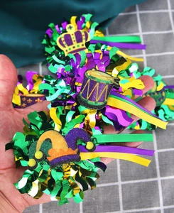 Detail of Mardi Gras mini hats and crown pins with purple gold green ribbons