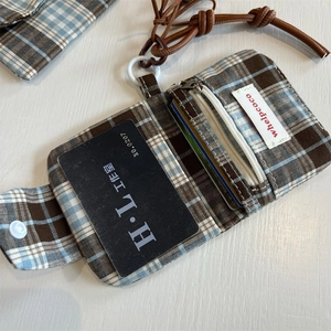 Close-up of vintage plaid wallet with zipper pocket and adjustable neck strap