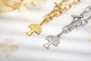 Close-up of gold and silver life tree bracelets with heart leaves and T-bar toggle clasp