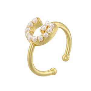 Close-up of golden adjustable open ring with elegant white pearl and U-shaped detail