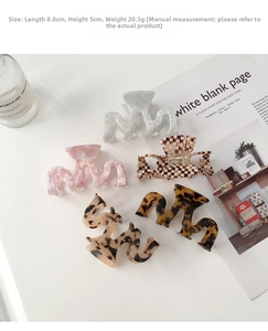Detailed size view showing 8.8cm M-shaped acetate hair claws in multiple stylish patterns