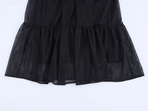 Detail of elegant black mesh ruffles and layered hemline on this stylish long dress
