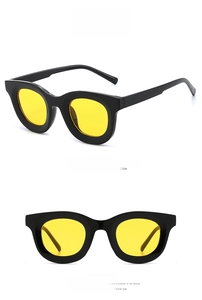 Retro thick-frame sunglasses with glossy black frames and bright yellow lenses