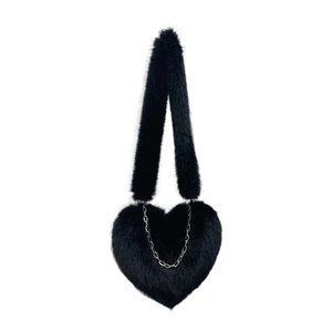 Black heart-shaped faux fur crossbody bag with plush strap and silver chain detail