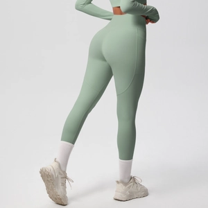 Detail of mint green high-waisted yoga pants with side pockets and ergonomic seams