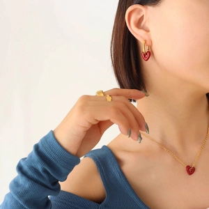 Elegant gold jewelry set with burgundy enamel heart pendants for a minimalist look