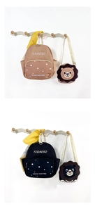 Detail view of khaki and navy toddler backpacks with detachable lion shaped mini bags