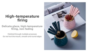 Detailed view of honeycomb textured ceramic jars and gold-rimmed stainless steel forks