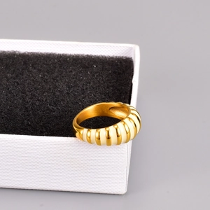 Retro 18K gold plated titanium ring with white enamel stripes on a jewelry box