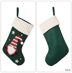 Front and back detail of green knit Christmas stocking with gnome and snowflake design