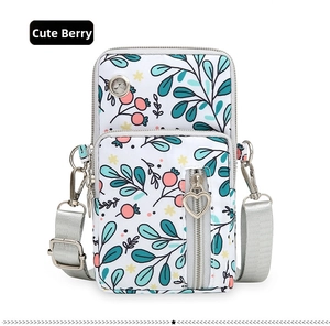 Detail of berry floral phone crossbody bag with three zippers and a headphone port