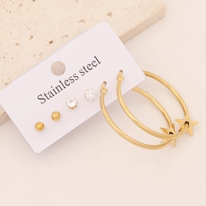 Detail of 3 pairs stainless steel gold earrings set with star charms and zircon studs