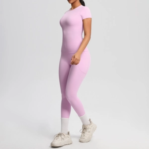 Side view of pink yoga set with breathable short-sleeve top and leggings featuring side pockets
