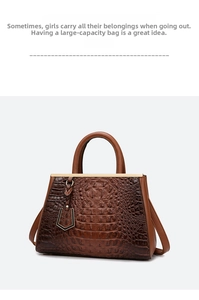 Close-up of brown crocodile pattern embossed leather tote with elegant gold metal accents
