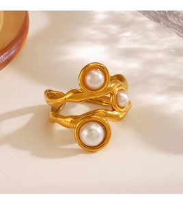 Detailed view of irregular wavy gold-plated ring with three elegant pearls