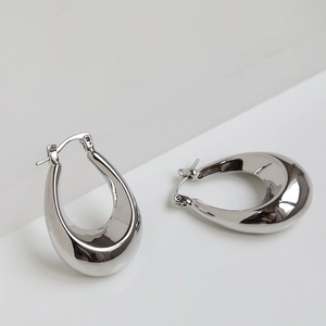 Polished silver oval hoop earrings in a minimalist thick curved design for women
