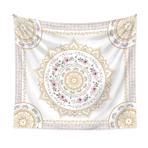 Close-up of bohemian mandala tapestry featuring pink roses and golden floral patterns