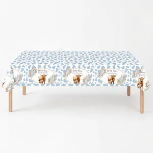 Highland cow baby shower table cloth featuring blue spot prints and baby party theme