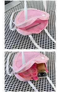 Pink heart-shaped ita bag showing interior storage capacity and metal zipper detail