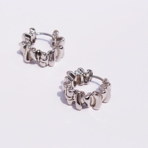 Modern silver earrings with irregular lava texture and minimalist geometric hoop design