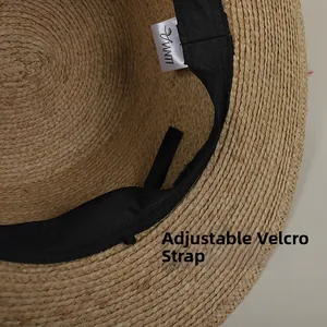 Close-up of raffia sun hat interior featuring adjustable velcro strap and sweatband