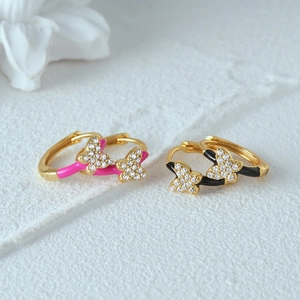 Detail of butterfly hoop earrings with pink and black enamel and sparkling zircon stones