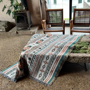 Bohemian style camping blanket with geometric tribal patterns and fringe edge trim
