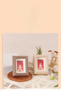 Close-up of walnut and natural wood photo frames with motivational Chinese gift cards