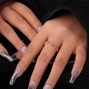 Detailed view of 18K gold plated ring with continuous purple heart-shaped zircons