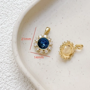 Detailed macro view of 14mm sunflower pendant with 18k gold plating and blue zircon