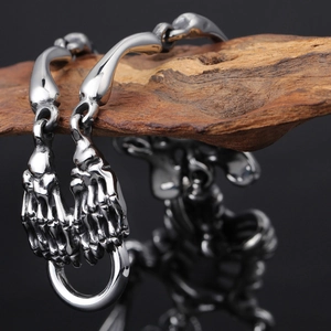 Gothic stainless steel bracelet featuring two skeleton hands holding a metal ring