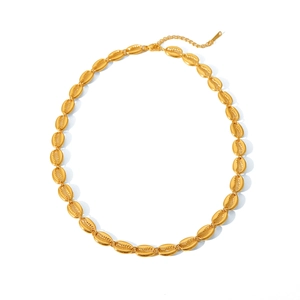 Detailed shot of golden shell-link necklace with adjustable extender chain and clasp
