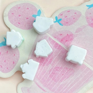 Detailed view of mini white castle resin parts for DIY hairpins and phone case decor