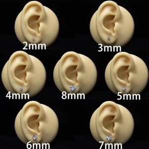 Surgical steel zircon stud earrings shown in sizes from 2mm to 8mm on ear models