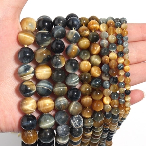 Detailed view of natural tiger eye stone beads in gold, blue, and brown tones for DIY jewelry