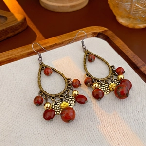 Ethnic teardrop tassel earrings with red beads and bronze metal in bohemian style