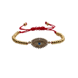 Adjustable red rope bracelet with gold beads and evil eye charm with blue crystal stones