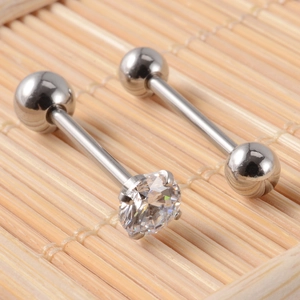 Polished stainless steel tongue ring set with clear cubic zirconia stud on bamboo background