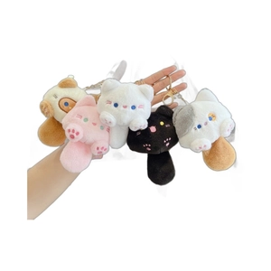 Set of five colorful plush cat keychains in white pink black and grey on a white background