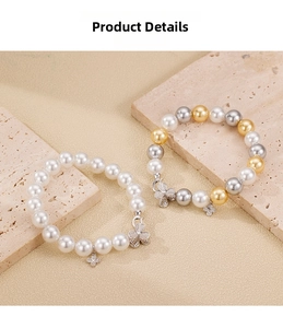 Detailed macro view of 925 silver pearl bracelet with clover charm and zircon inlay