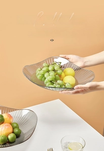 Macro detail of grey transparent fruit plate with vertical stripes and wavy edge