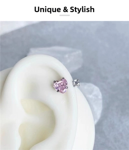 Detail of pink heart-shaped zircon and round diamond stud earrings on ear model