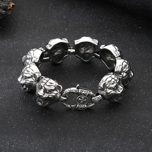 Detailed close-up of a silver tiger head link bracelet with intricate metal carvings