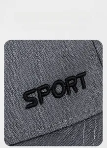 Detail of SPORT 3D embroidery on dark grey high-density fabric of the sun hat