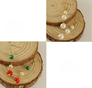 Macro detail showing 18k gold plating finish on pearl and agate drop earrings
