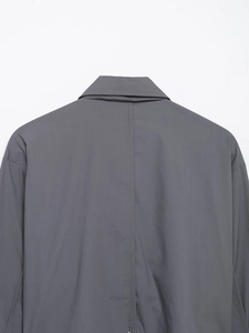 Close-up of the back collar and precision stitching on the dark grey poplin shirt