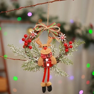 Christmas wreath featuring a plush reindeer with festive red scarf and snowy pine branches