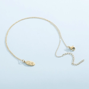 Detail of gold pendant necklace with embossed religious figure and lobster clasp