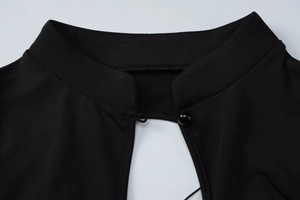 Close-up of black sexy mini dress featuring a cutout neckline and chic frog button detail